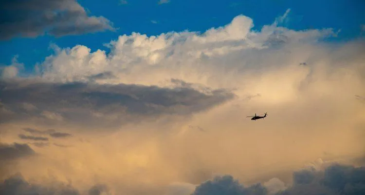 A helicopter flying in the skyDescription automatically generated