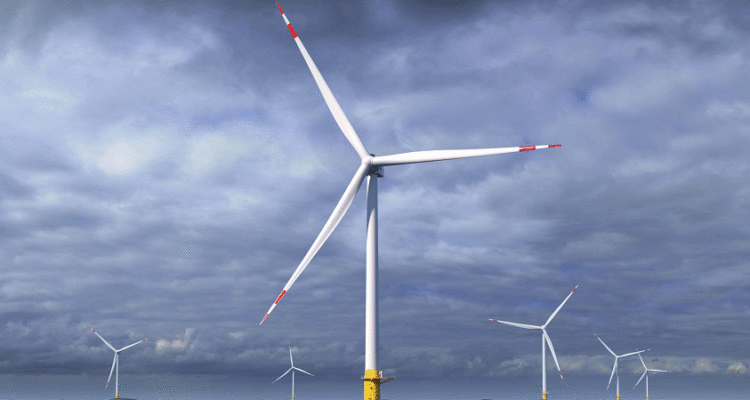 A wind turbines in a fieldDescription automatically generated