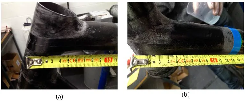 The head tube joint during hand lamination, with the optical fiber FBG sensor routed by hand across the joint and taped in position before the carbon plies close over it.