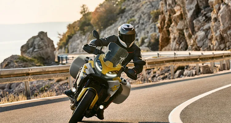 A person riding a motorcycle on a roadDescription automatically generated