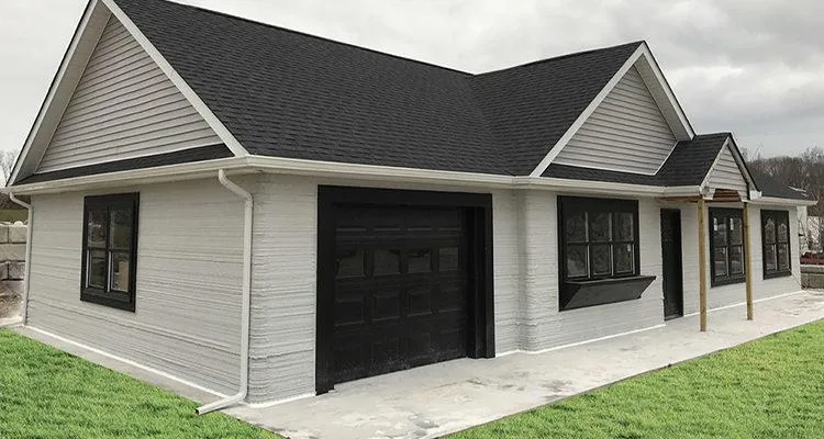 A house with a garageDescription automatically generated