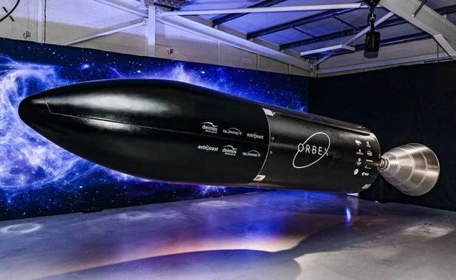 A black rocket in a roomDescription automatically generated
