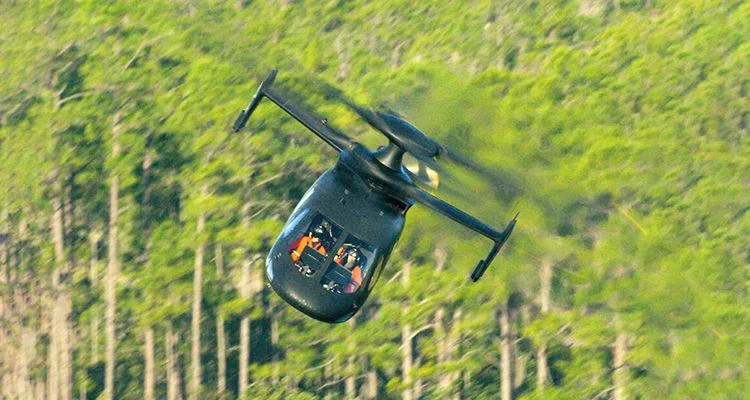 A helicopter flying through the airDescription automatically generated