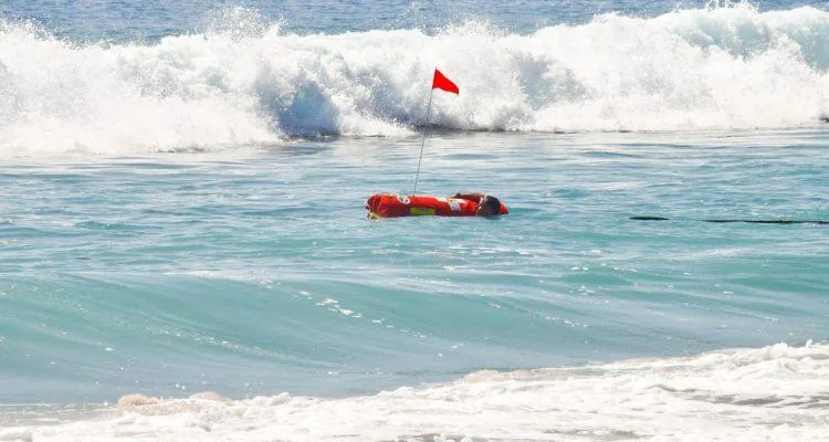 A person in a buoy in the oceanDescription automatically generated