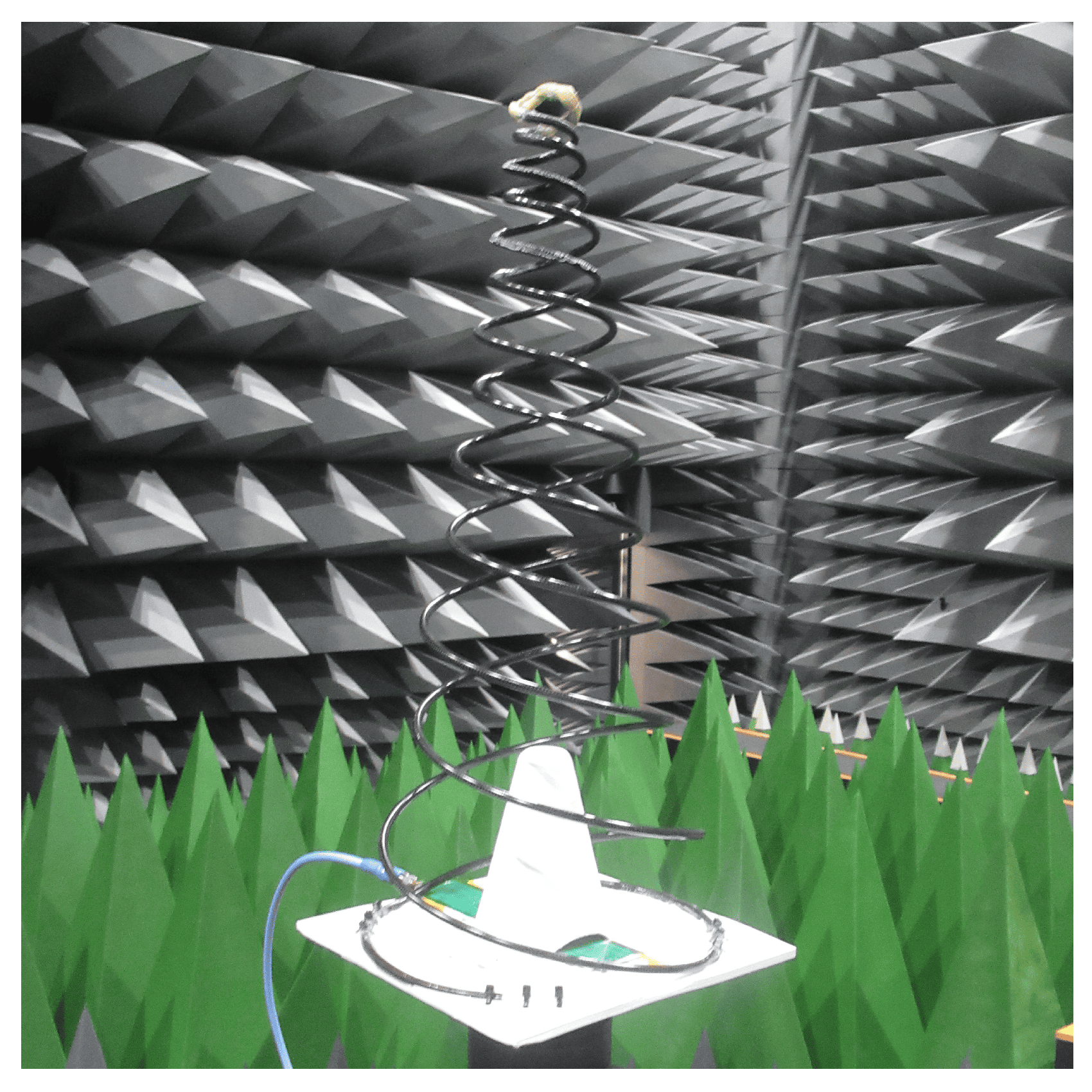 The deployed conical spring antenna hanging from its apex inside an anechoic chamber