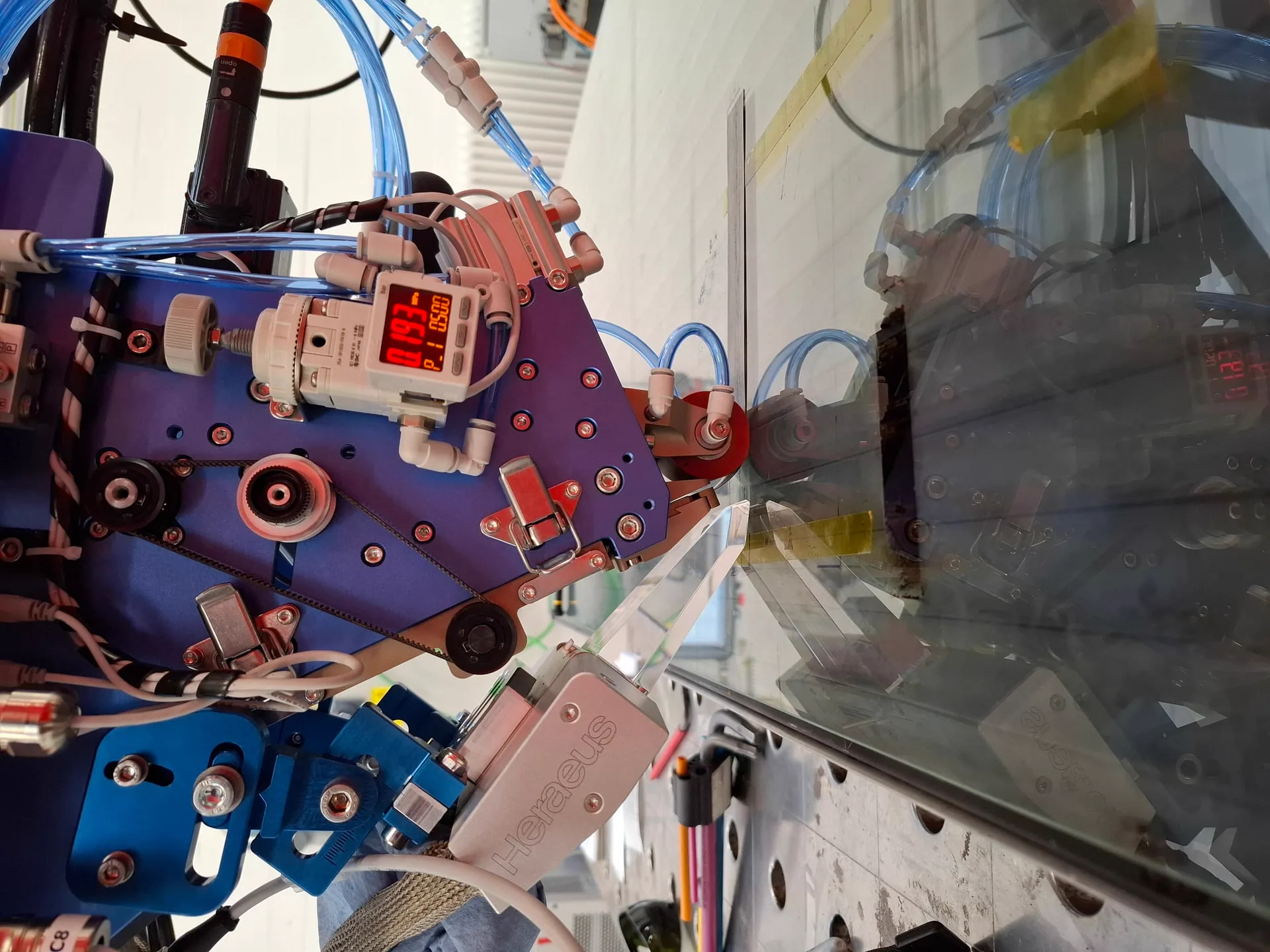 Close view of an Addcomposites process head during material testing