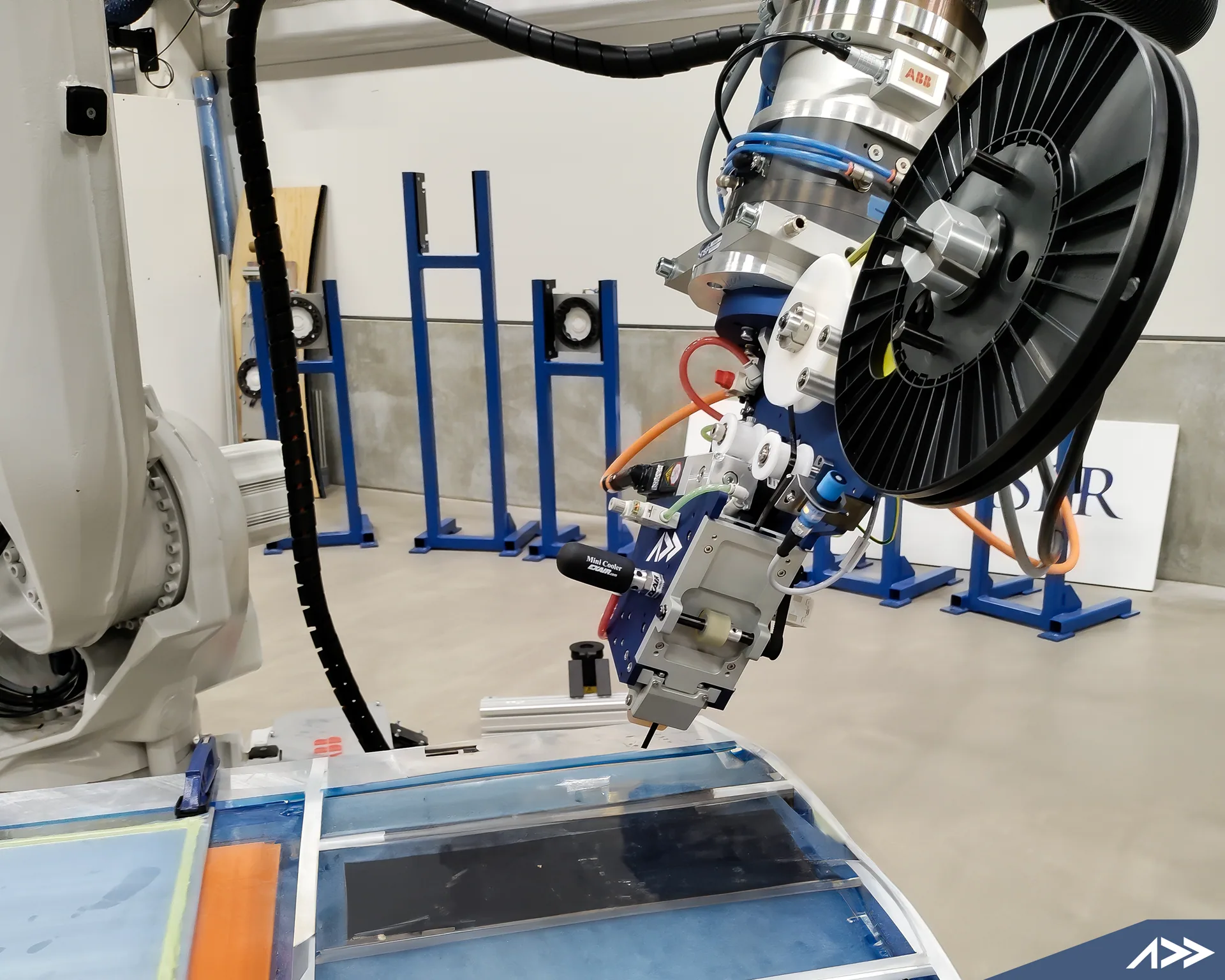 AFP-XS automated fiber-placement head integrated with an ABB industrial robot
