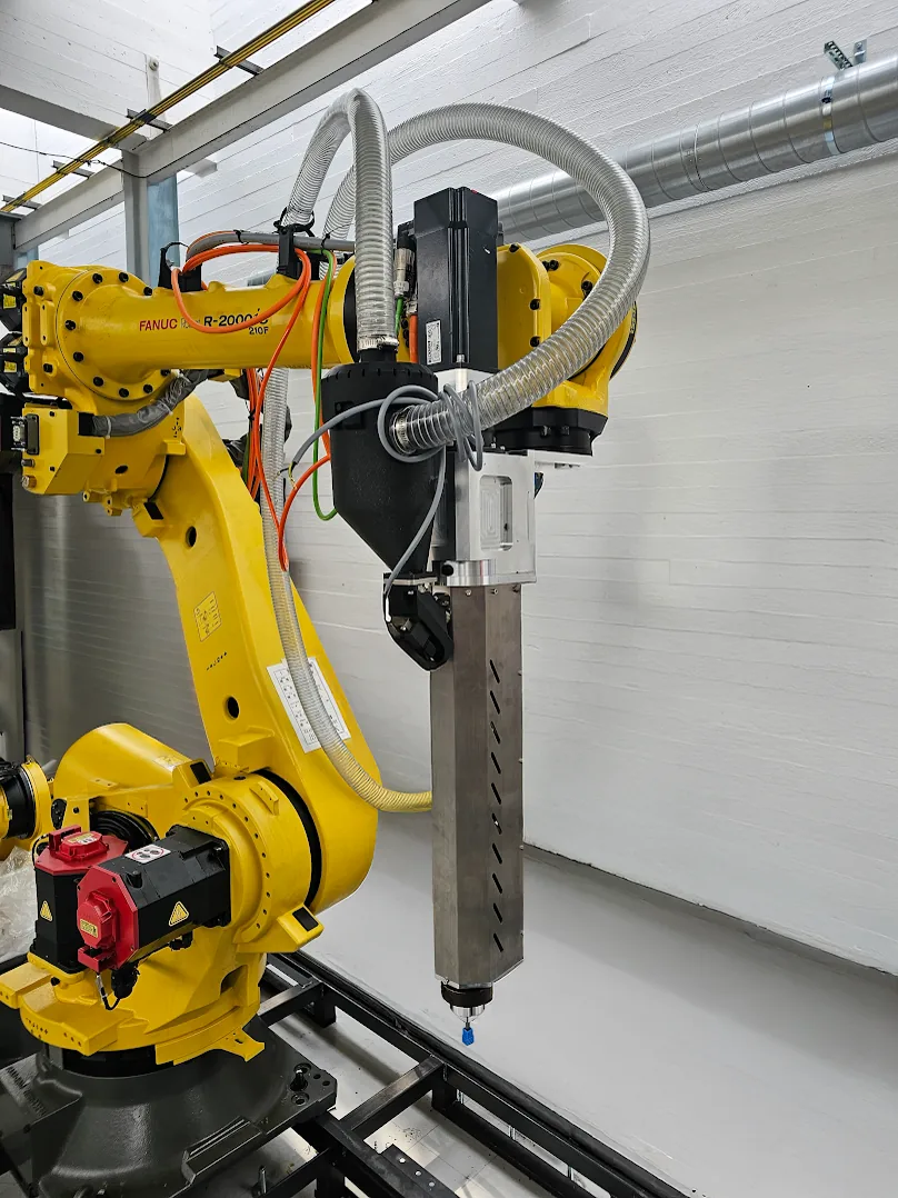 Real AddX large-format additive-manufacturing head mounted on a FANUC robot