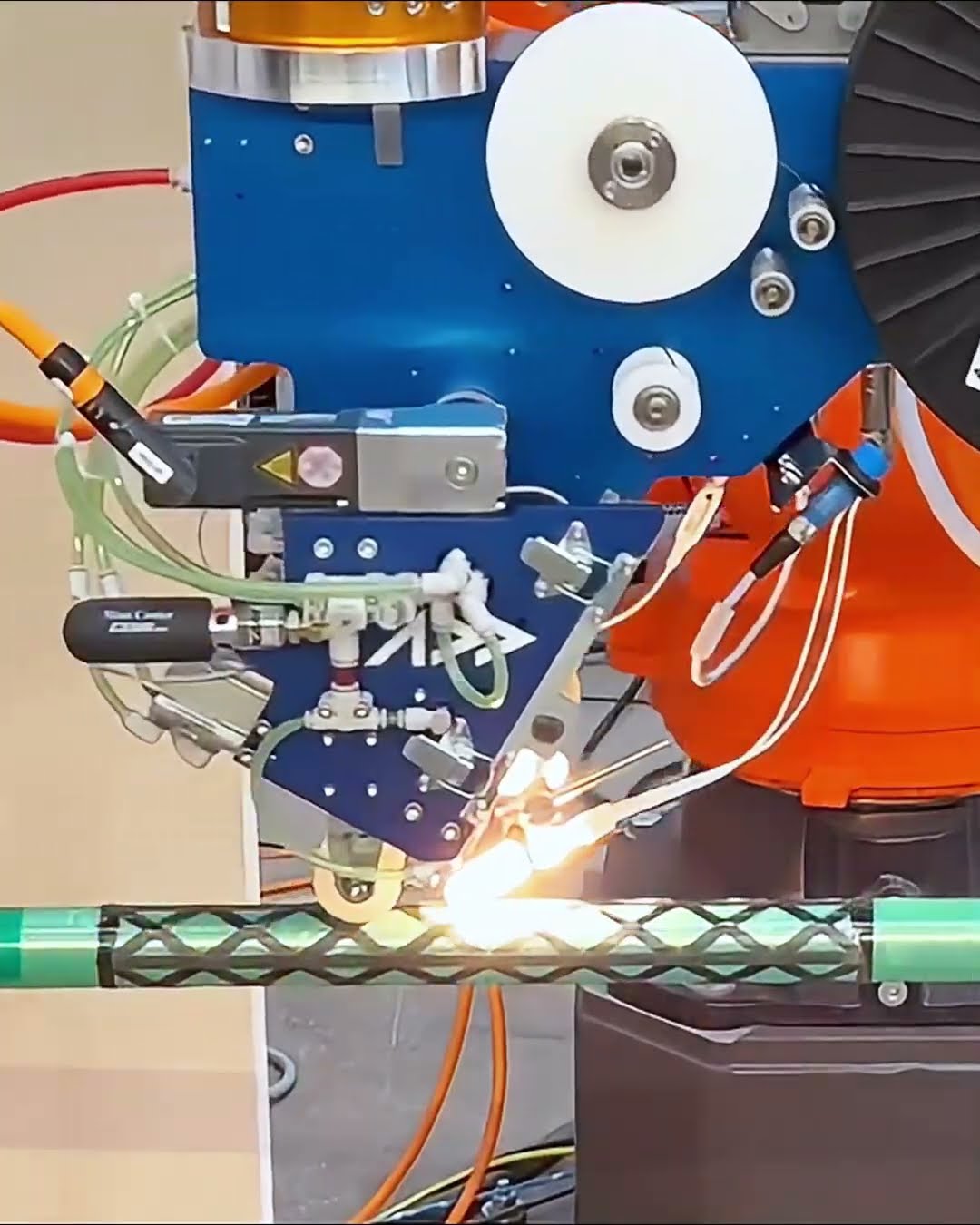 AFP system placing continuous fiber around a cylindrical composite structure